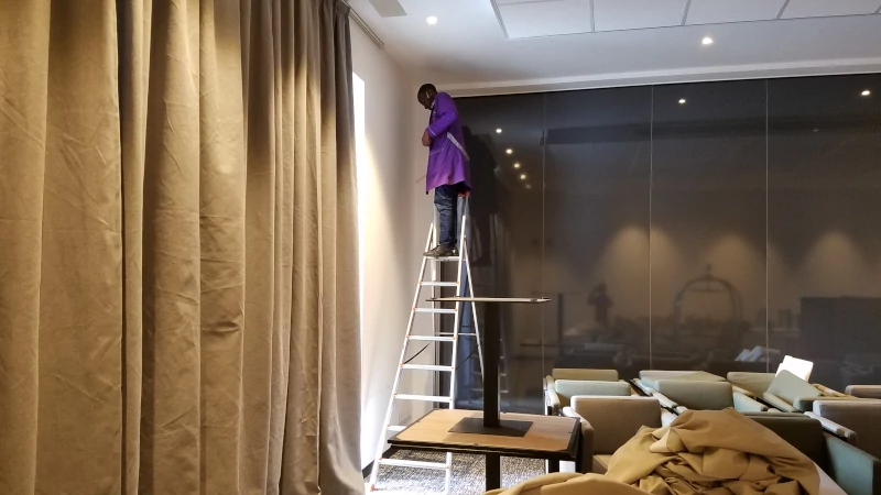 lubbeger technician installing curtains
